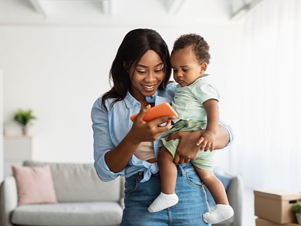 Mother showing young child a smartphone